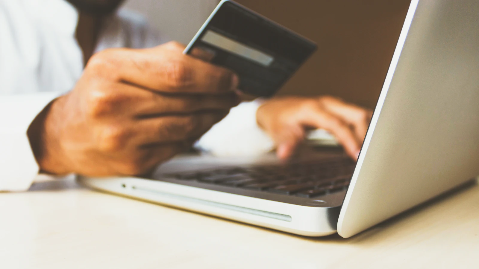 Customer entering payment details on a laptop during an online purchase